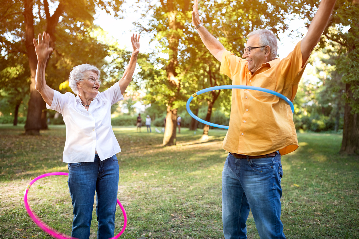 Older couple hula hooping
